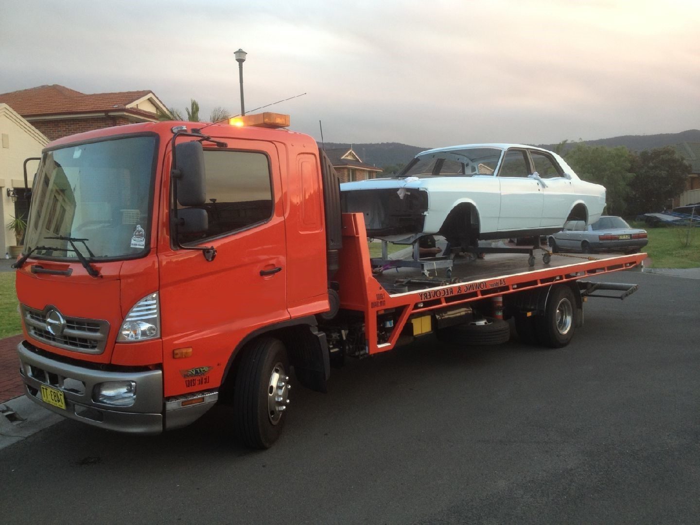 MTJ Towing tilt tray truck with a classic Ford loaded