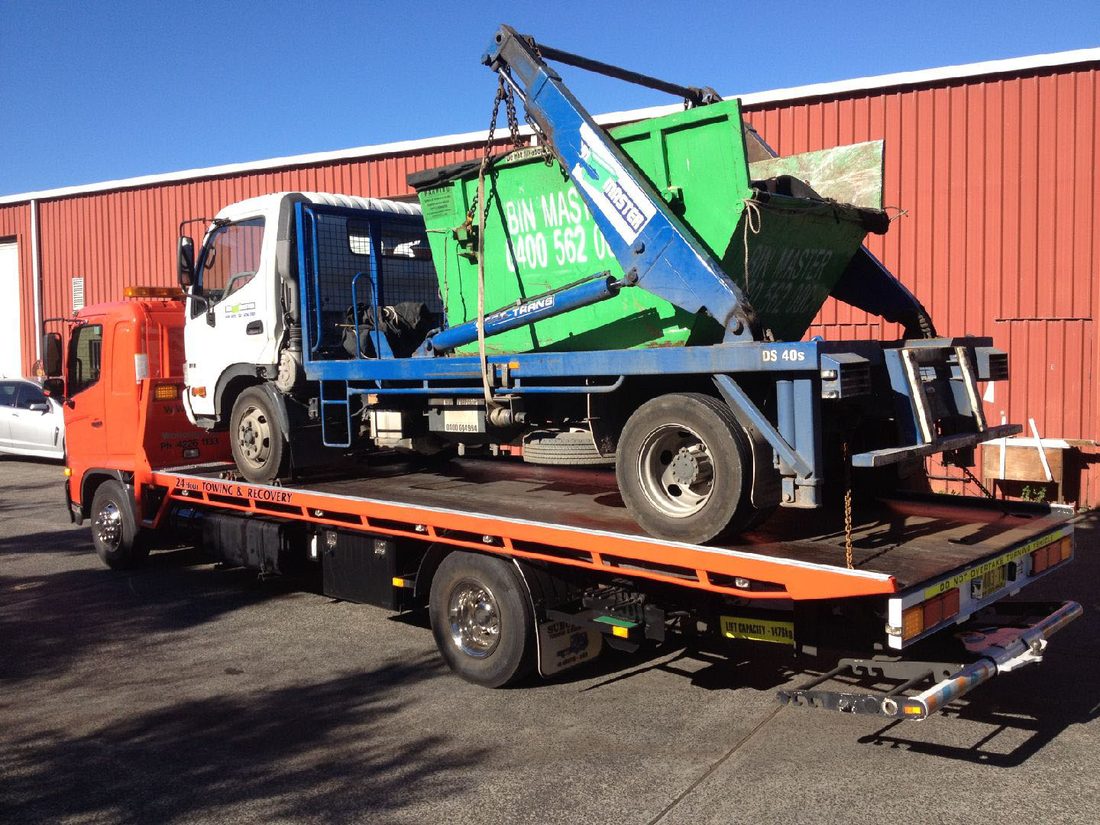 Skip bin truck being transported by MTJ Towing