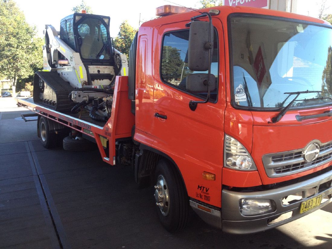 Bobcat skid steer loaded on the MTJ Towing tilt tray